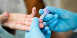 Blood sample being taken from a finger